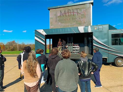Staging Truck and TV Screen surrounded by students